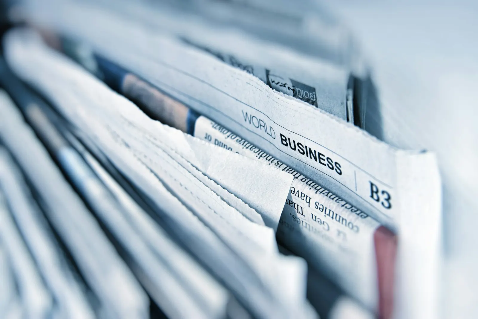 A stack of folded business newspapers.